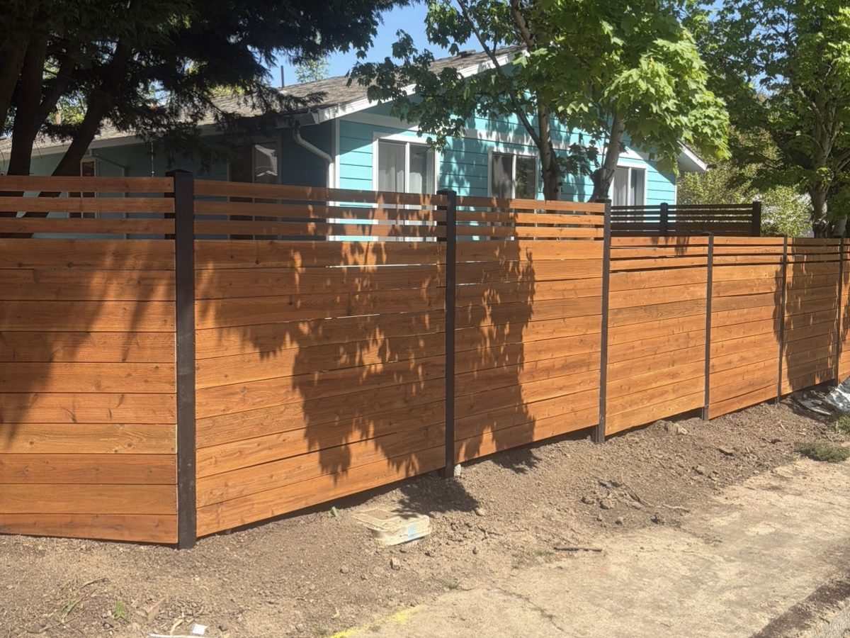 Custom horizontal cedar privacy fence with black posts